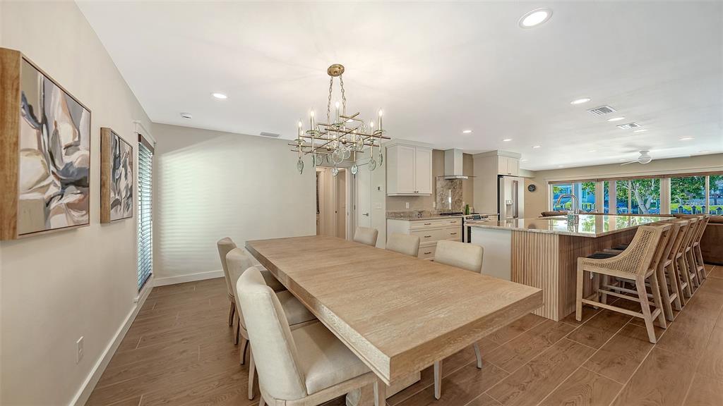 690 Old Compass Road Longboat Key, FL 34228 - Photo 12 of 69 a view of a dining room with furniture and a chandelier