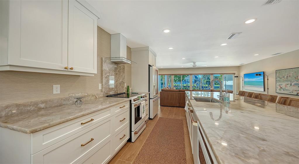690 Old Compass Road Longboat Key, FL 34228 - Photo 17 of 69 a large kitchen with stainless steel appliances granite countertop a lot of counter space and a sink