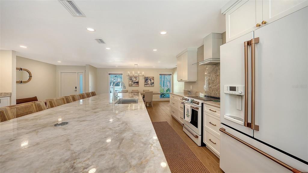690 Old Compass Road Longboat Key, FL 34228 - Photo 19 of 69 a kitchen with stainless steel appliances a refrigerator sink and stove