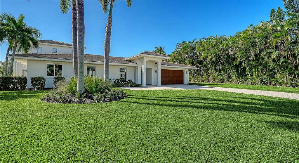 690 Old Compass Road Longboat Key, FL 34228 - Photo 2 of 69 a front view of house with yard and green space
