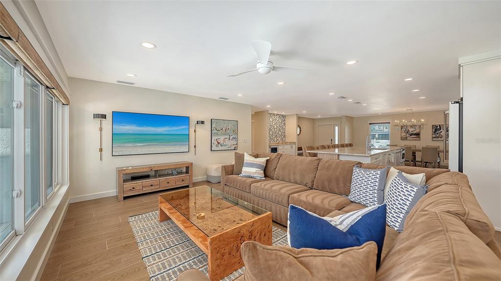 690 Old Compass Road Longboat Key, FL 34228 - Photo 23 of 69 a living room with furniture and a flat screen tv