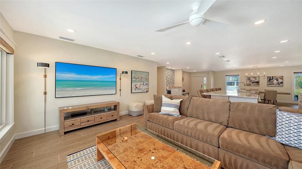 690 Old Compass Road Longboat Key, FL 34228 - Photo 24 of 69 a living room with furniture and a flat screen tv