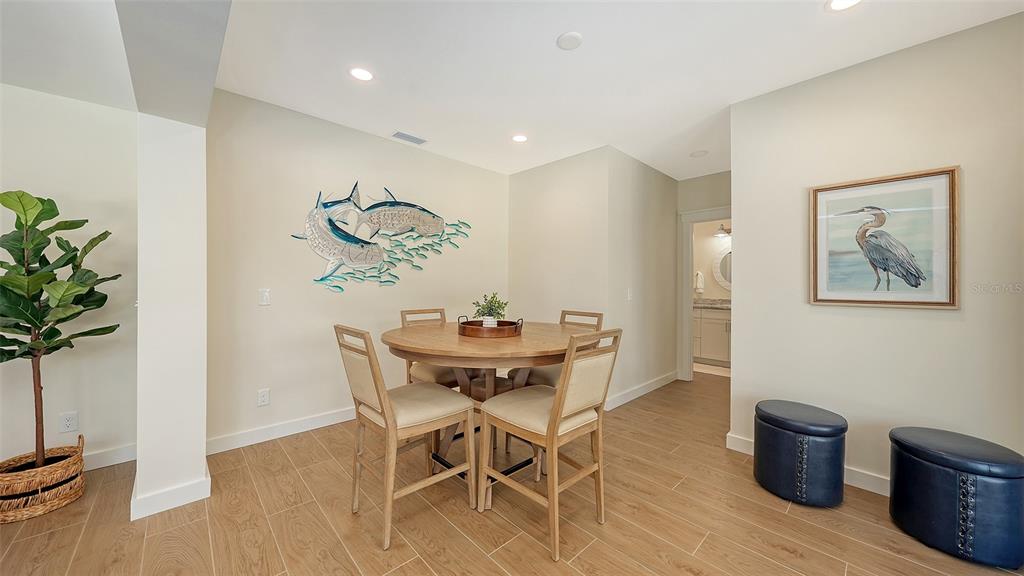 690 Old Compass Road Longboat Key, FL 34228 - Photo 26 of 69 a view of a dining room with furniture and wooden floor