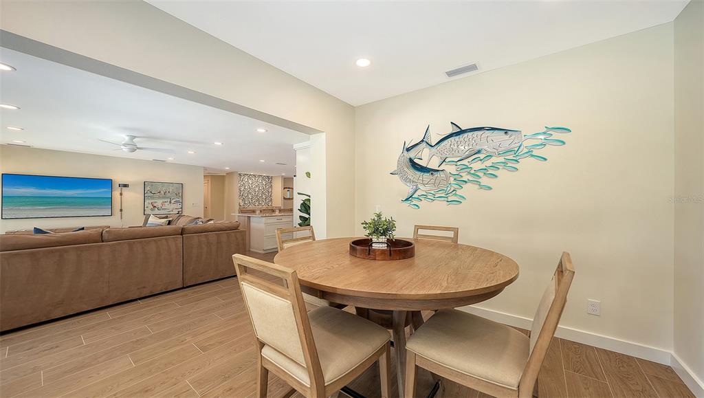 690 Old Compass Road Longboat Key, FL 34228 - Photo 27 of 69 a kitchen with a table and chairs in it