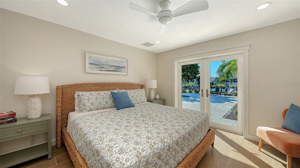 690 Old Compass Road Longboat Key, FL 34228 - Photo 29 of 69 a bedroom with a large bed and a lamp on dresser