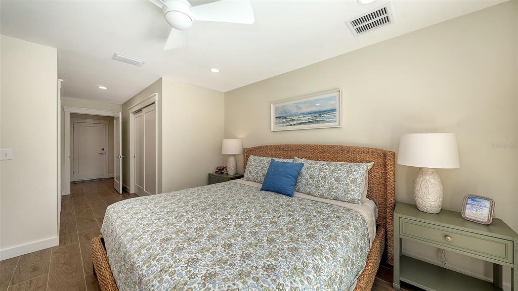690 Old Compass Road Longboat Key, FL 34228 - Photo 31 of 69 a bedroom with a bed and a night stand