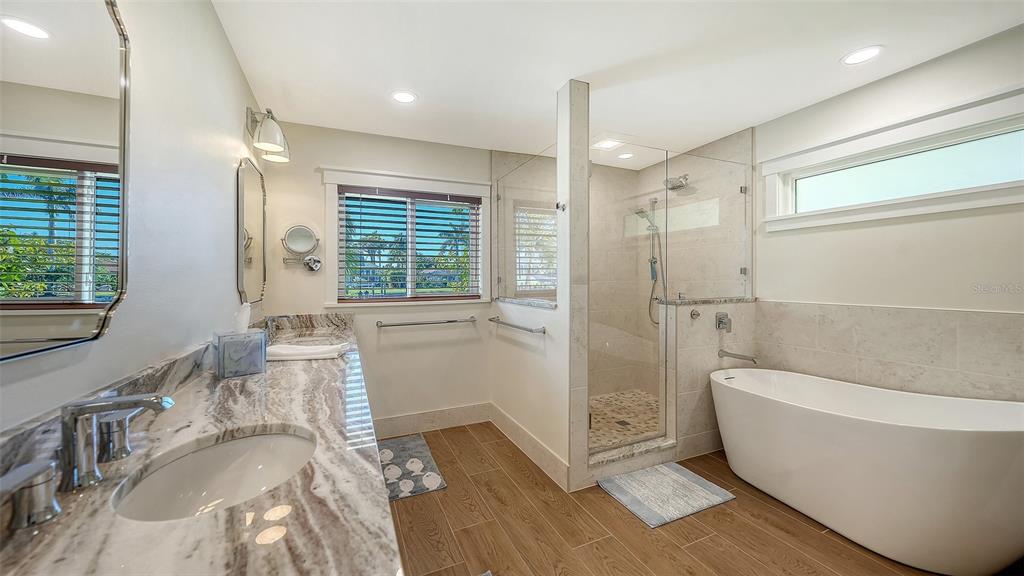 690 Old Compass Road Longboat Key, FL 34228 - Photo 33 of 69 a bathroom with a granite countertop tub sink and mirror