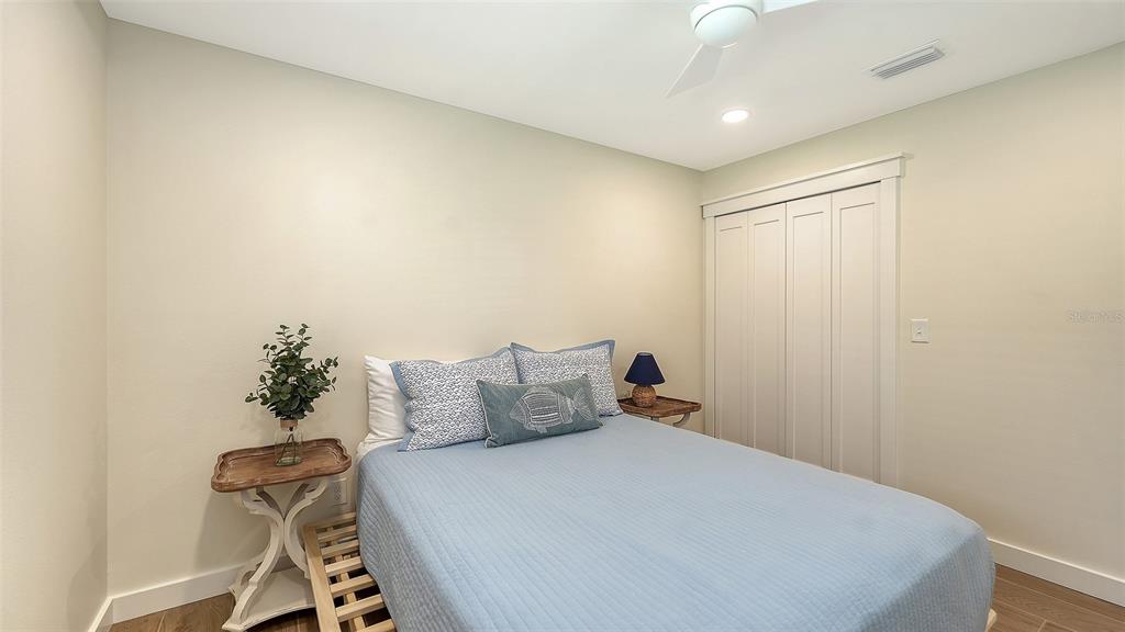 690 Old Compass Road Longboat Key, FL 34228 - Photo 39 of 69 a bedroom with a bed and a chandelier