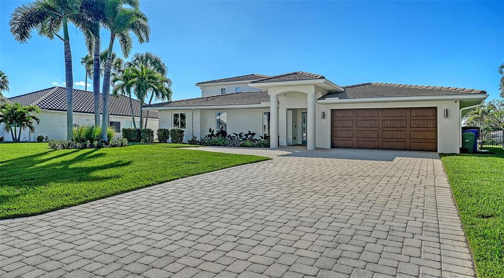 690 Old Compass Road Longboat Key, FL 34228 - Photo 4 of 69 a front view of a house with a yard and potted plants