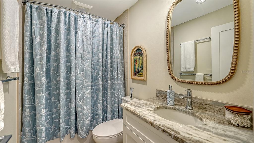 690 Old Compass Road Longboat Key, FL 34228 - Photo 41 of 69 a bathroom with a granite countertop bathtub sink vanity mirror and toilet