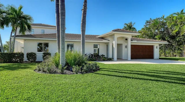 a front view of a house with a garden and yard