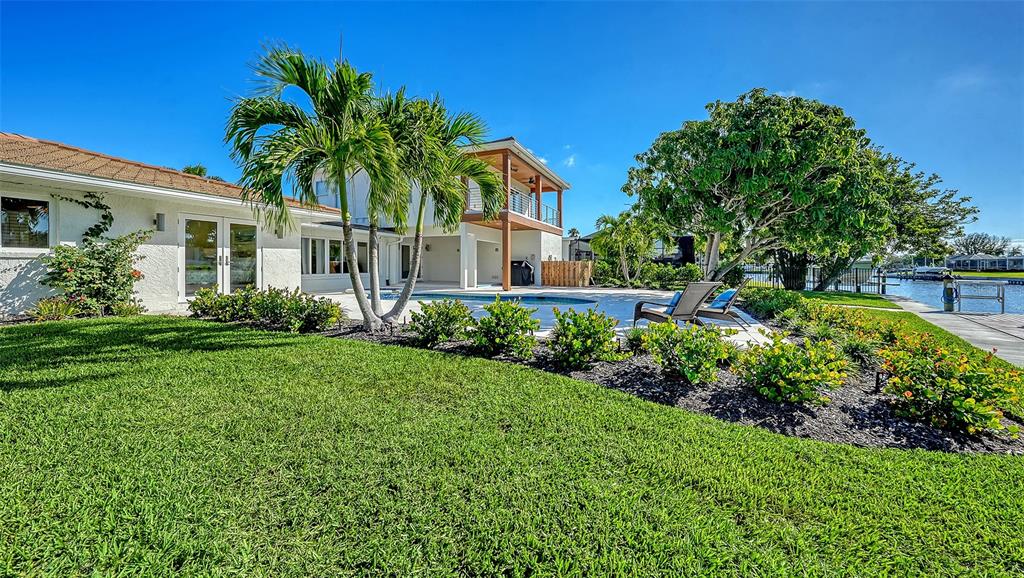 690 Old Compass Road Longboat Key, FL 34228 - Photo 61 of 69 a front view of a house with a garden