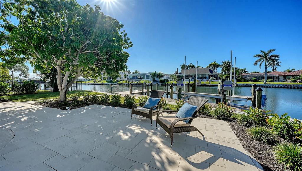 690 Old Compass Road Longboat Key, FL 34228 - Photo 64 of 69 a view of a patio with couches and table and chairs and potted plants