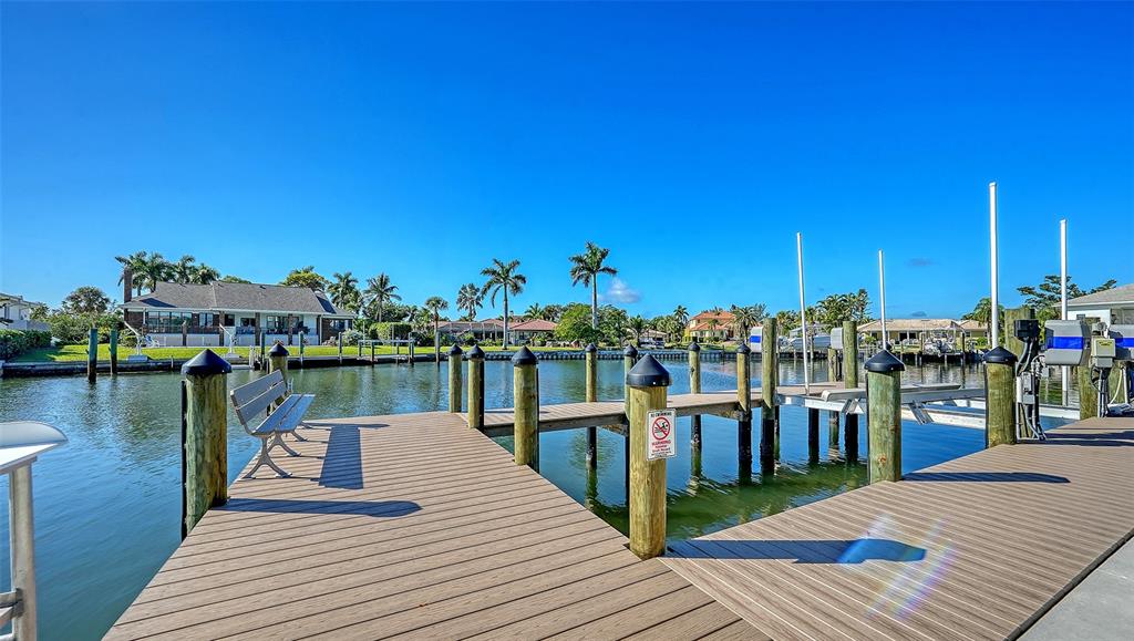 690 Old Compass Road Longboat Key, FL 34228 - Photo 66 of 69 a view of a lake with boats and trees in the background