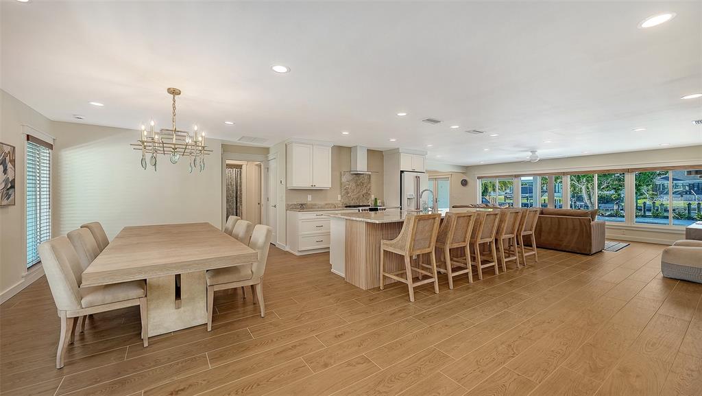 690 Old Compass Road Longboat Key, FL 34228 - Photo 9 of 69 a dining room with furniture a chandelier and wooden floor