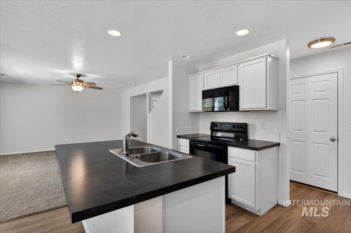 913 West Apple Pine Street Meridian, ID 83646 - Photo 12 of 32 Kitchen island with an undermount double-basin stainless steel sink and a contemporary faucet