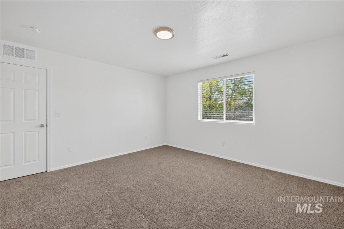 913 West Apple Pine Street Meridian, ID 83646 - Photo 14 of 32 Neutral painted walls with a single window featuring blinds