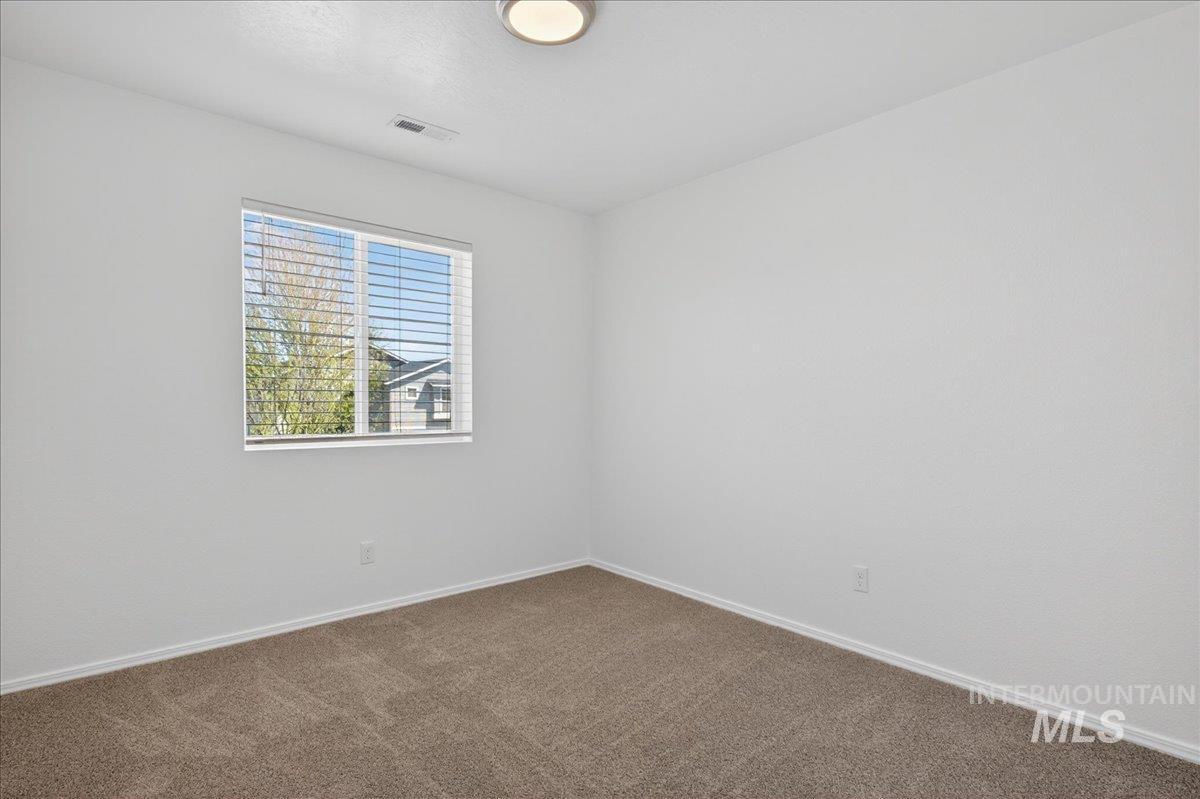 913 West Apple Pine Street Meridian, ID 83646 - Photo 16 of 32 Bright room featuring neutral carpeting, a white trim baseboard, and a window with horizontal blinds