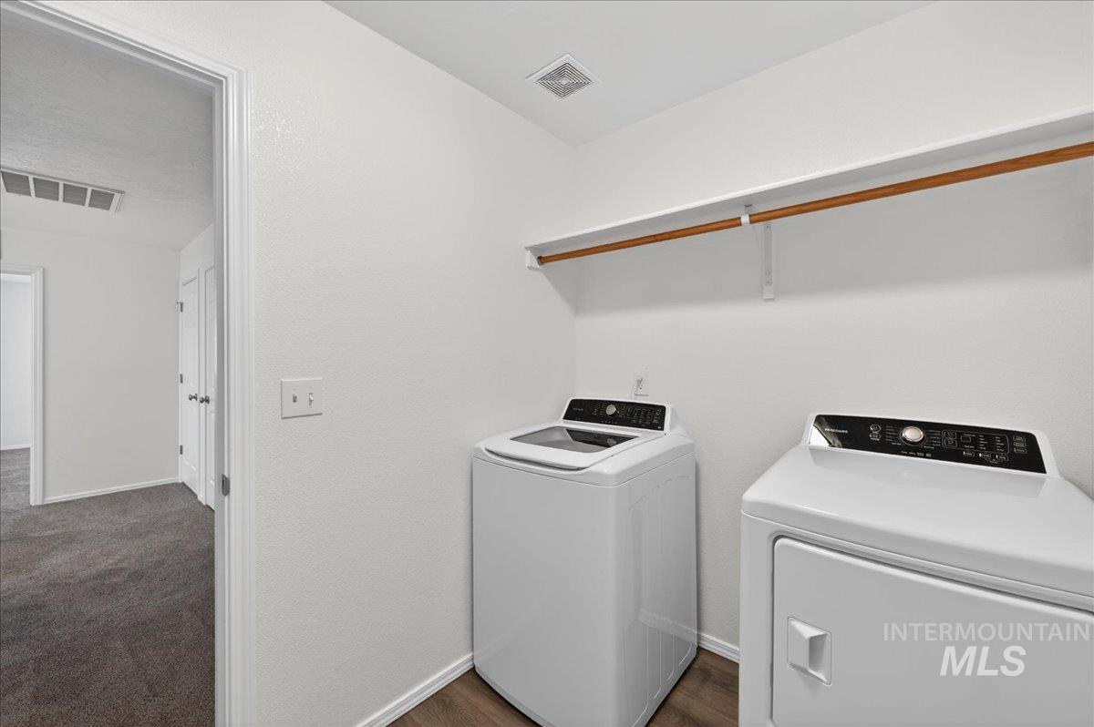 913 West Apple Pine Street Meridian, ID 83646 - Photo 24 of 32 Dedicated laundry area featuring wood-finish flooring, white walls, and an overhead storage shelf with hanging rod