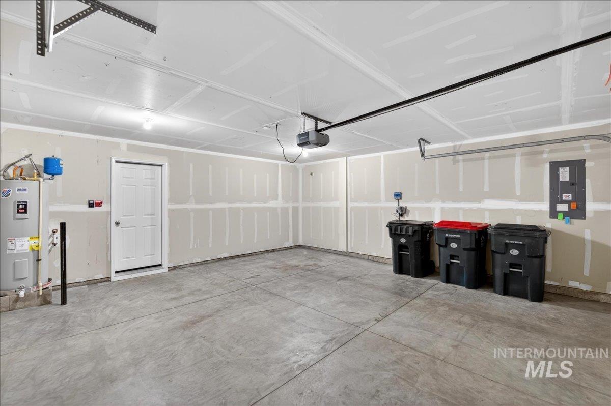 913 West Apple Pine Street Meridian, ID 83646 - Photo 26 of 32 Spacious garage featuring a concrete floor, painted drywall, and a ceiling-mounted garage door opener