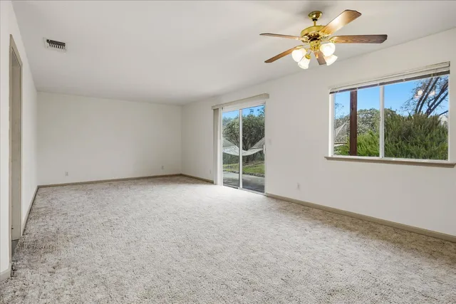 a view of a big room with windows and cabinet