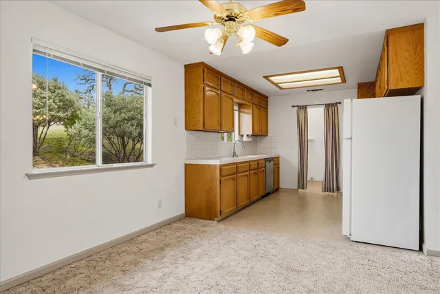 a kitchen with stainless steel appliances granite countertop a sink and cabinets