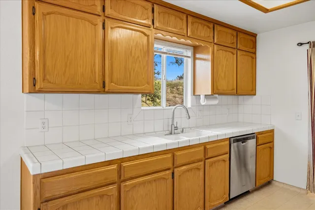a kitchen with a refrigerator a stove top oven