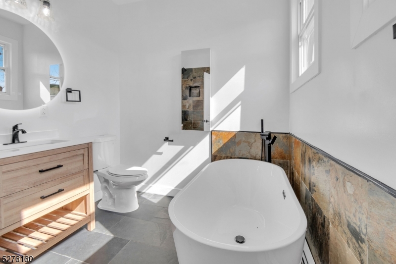 a en suite bathroom with a toilet sink and mirror