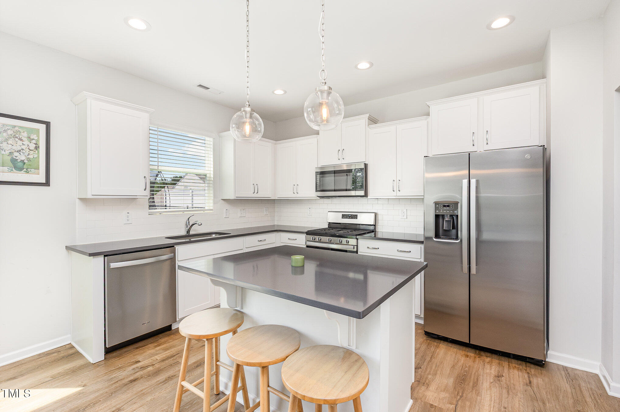 1101 Hazelmist Drive Wake Forest, NC 27587 - Photo 8 of 28 a kitchen with kitchen island a counter space a sink appliances and cabinets