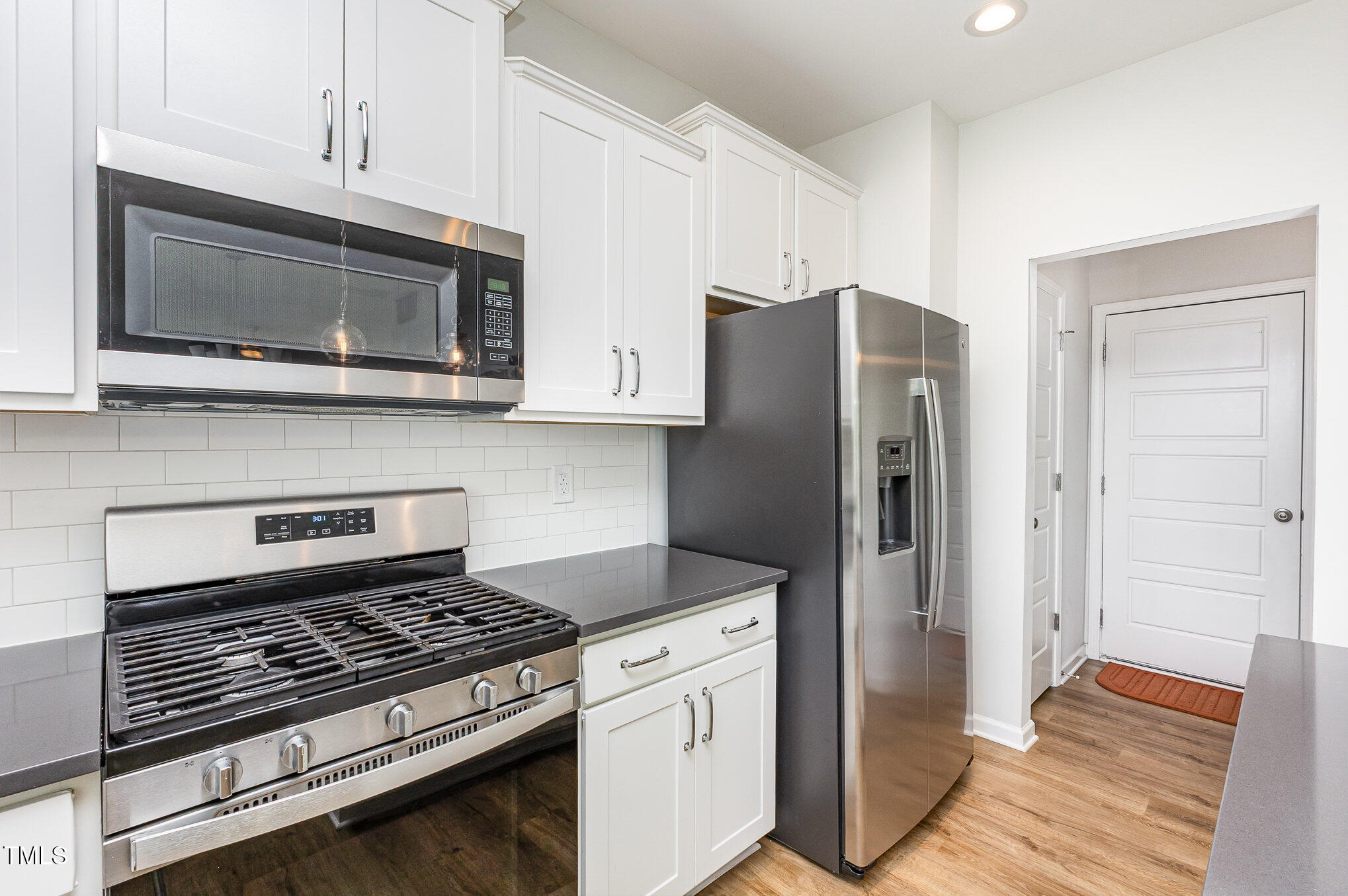 1101 Hazelmist Drive Wake Forest, NC 27587 - Photo 9 of 28 a kitchen with stainless steel appliances and cabinets