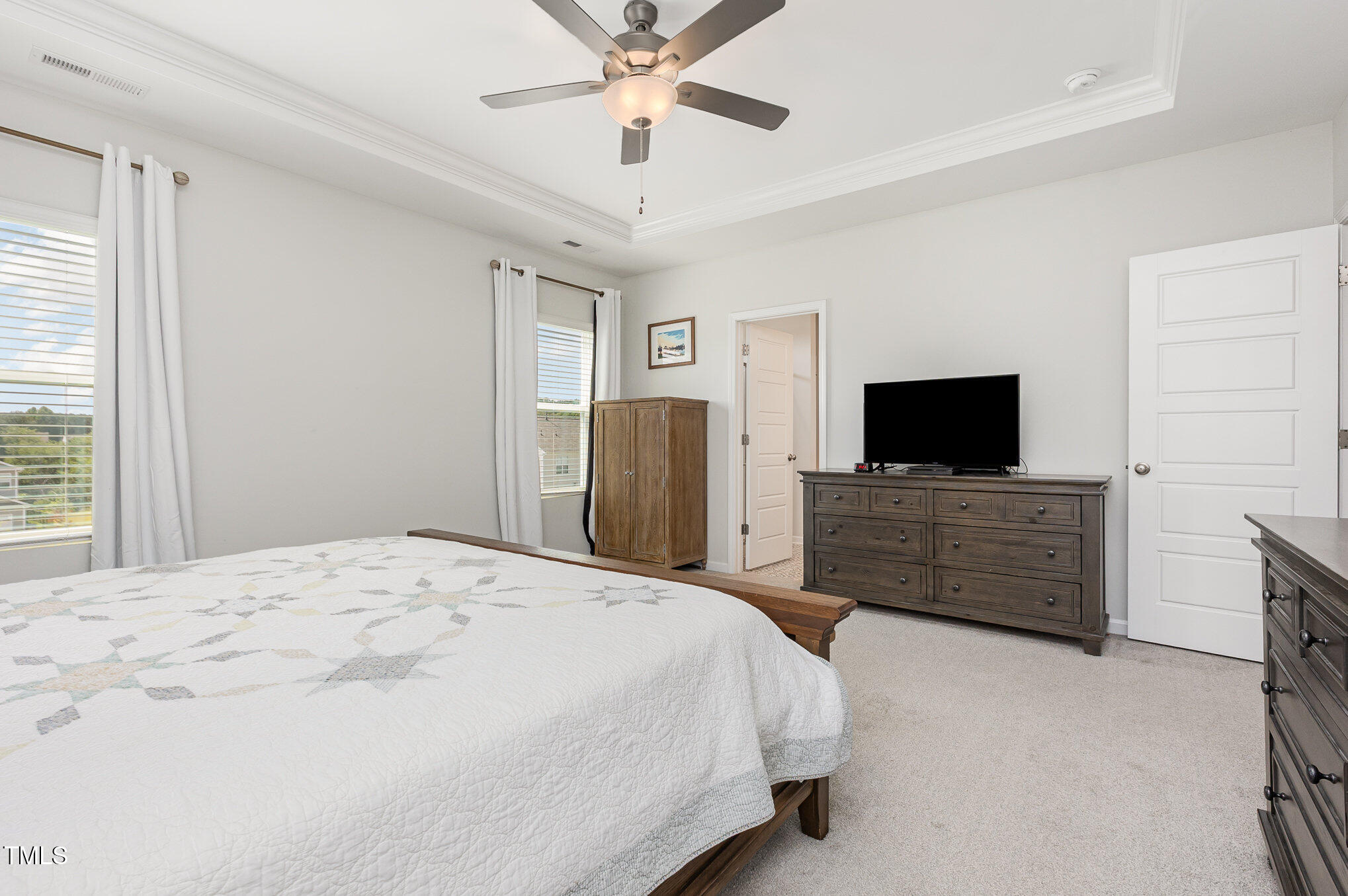 1101 Hazelmist Drive Wake Forest, NC 27587 - Photo 13 of 28 a bedroom with a bed and a flat screen tv