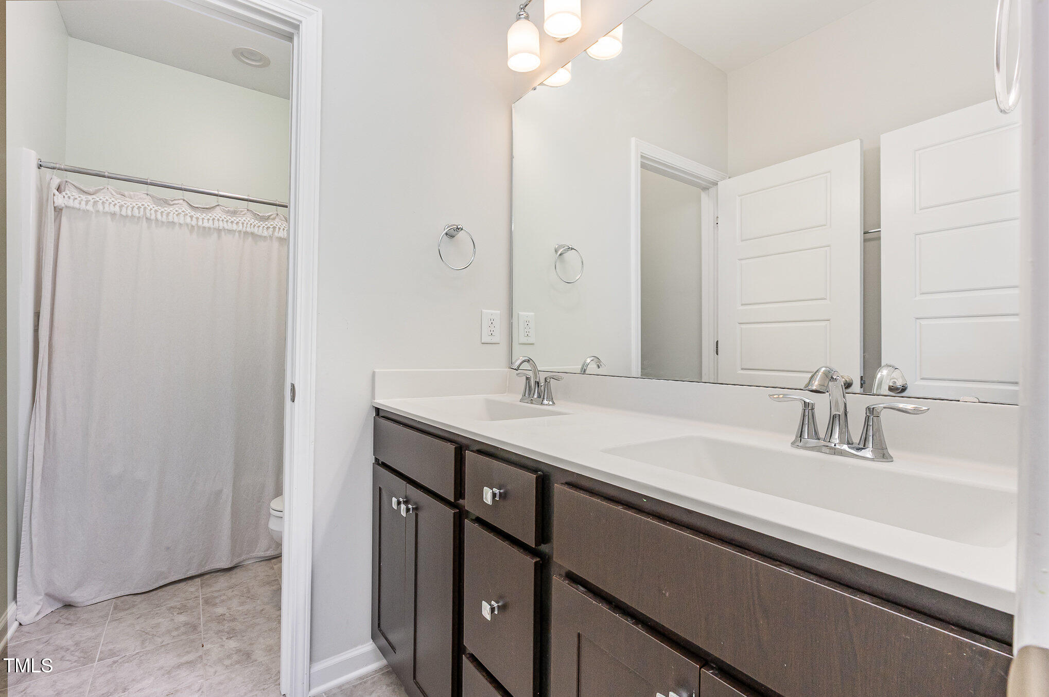 1101 Hazelmist Drive Wake Forest, NC 27587 - Photo 16 of 28 a bathroom with a sink and a mirror