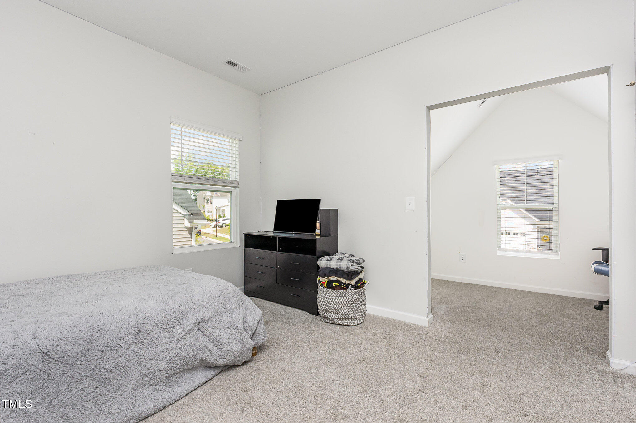 1101 Hazelmist Drive Wake Forest, NC 27587 - Photo 17 of 28 a bedroom with a bed and a flat screen tv