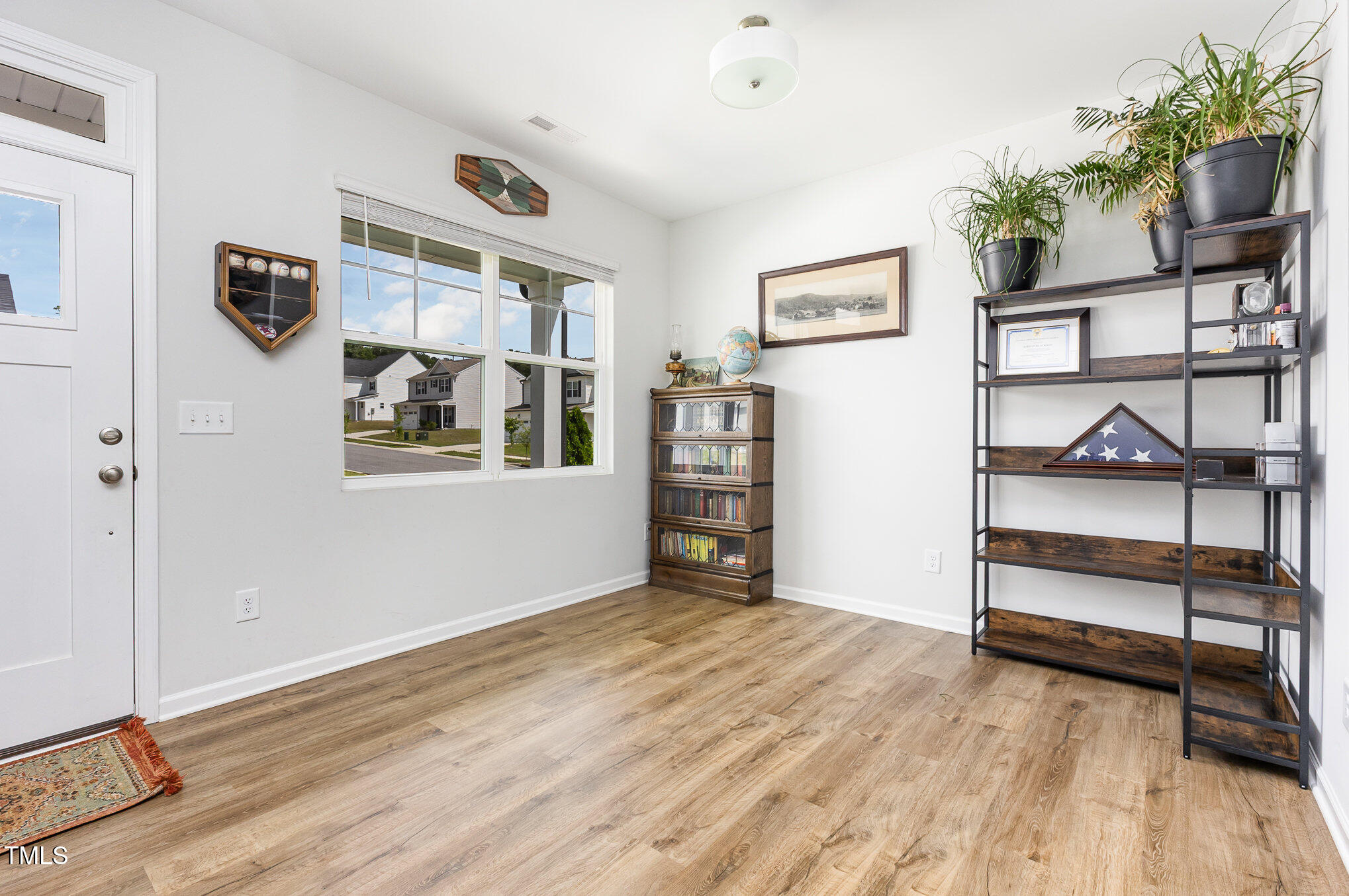 1101 Hazelmist Drive Wake Forest, NC 27587 - Photo 3 of 28 a view of an empty room with a window and wooden floor