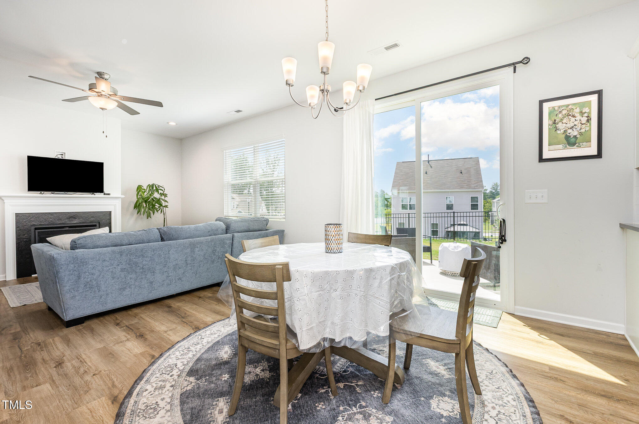 1101 Hazelmist Drive Wake Forest, NC 27587 - Photo 6 of 28 a living room with furniture a chandelier and a flat screen tv