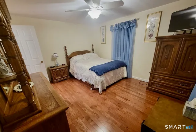 a bedroom with a bed and flat screen tv