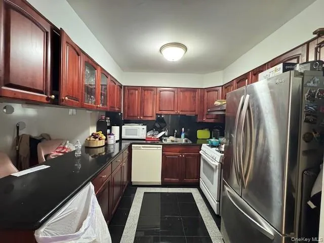 a kitchen with a refrigerator sink and stove