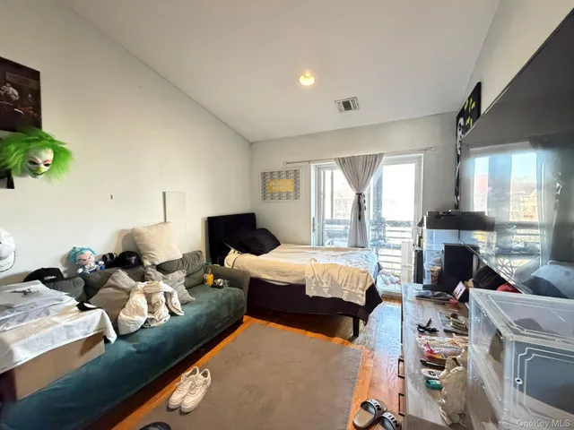 a bedroom with furniture and a large window