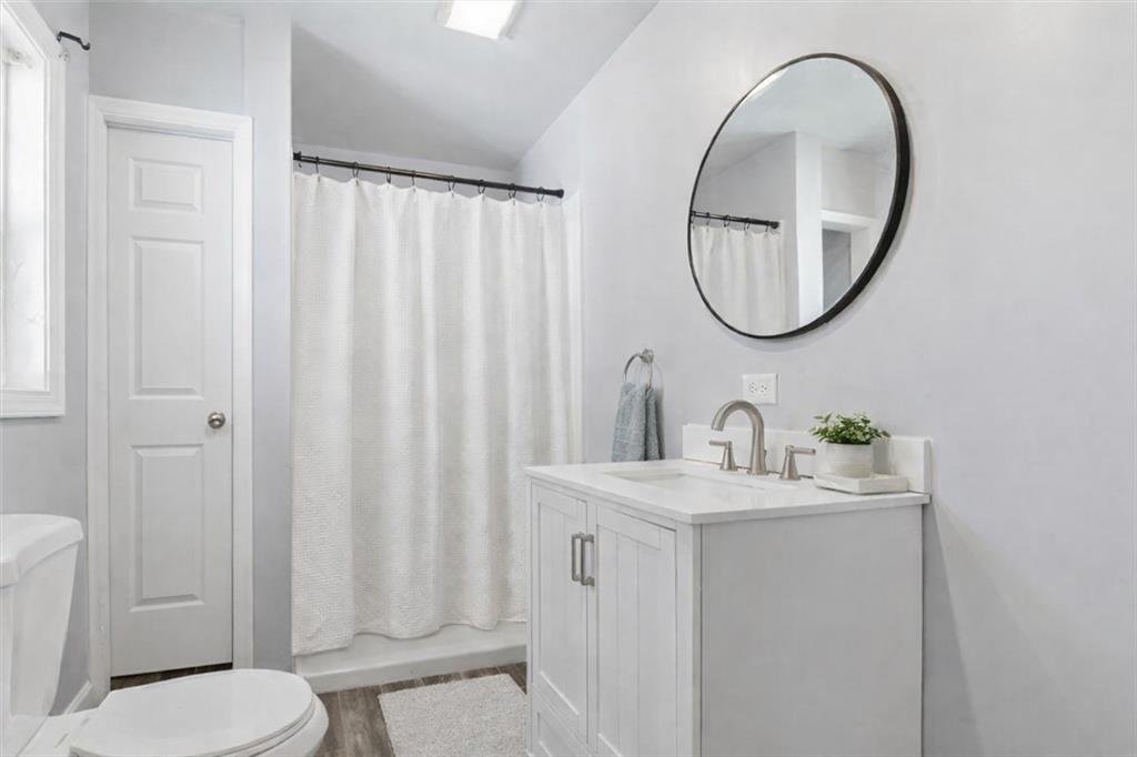 1500 Moores Ferry Road Southwest Plainville, GA 30733 - Photo 13 of 33 a bathroom with a sink a toilet and a mirror