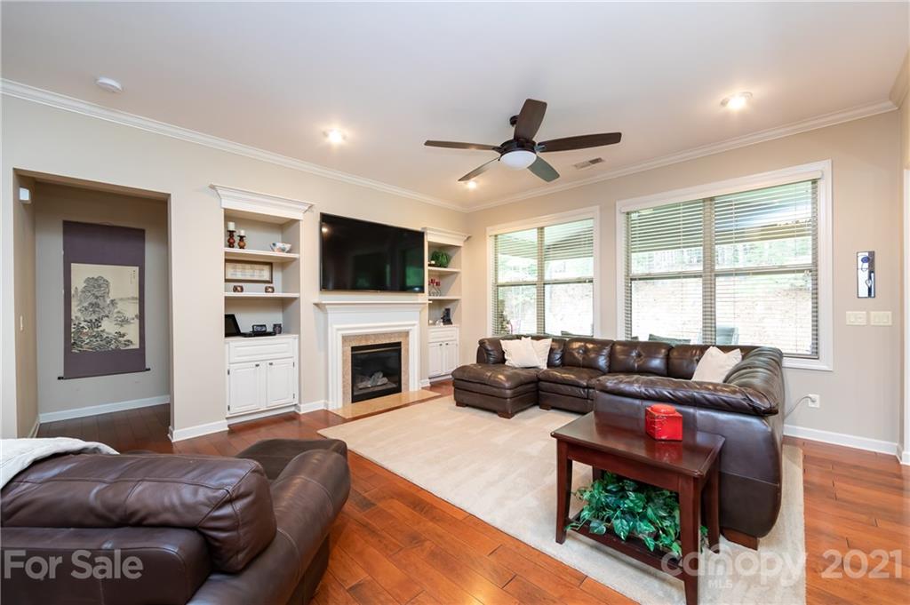2721 Twinberry Lane Waxhaw, NC 28173 - Photo 16 of 29 a living room with furniture a fireplace and a flat screen tv