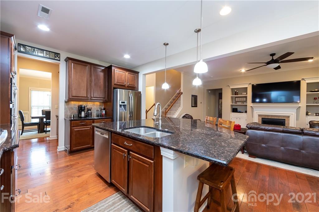 2721 Twinberry Lane Waxhaw, NC 28173 - Photo 17 of 29 a kitchen with stainless steel appliances granite countertop a sink counter space and wooden floor