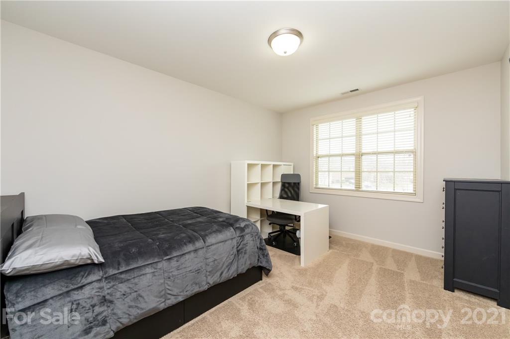 2721 Twinberry Lane Waxhaw, NC 28173 - Photo 22 of 29 a bedroom with a bed and a couch