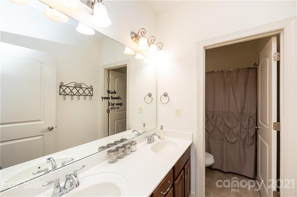 2721 Twinberry Lane Waxhaw, NC 28173 - Photo 23 of 29 a bathroom with a sink vanity granite and a mirror