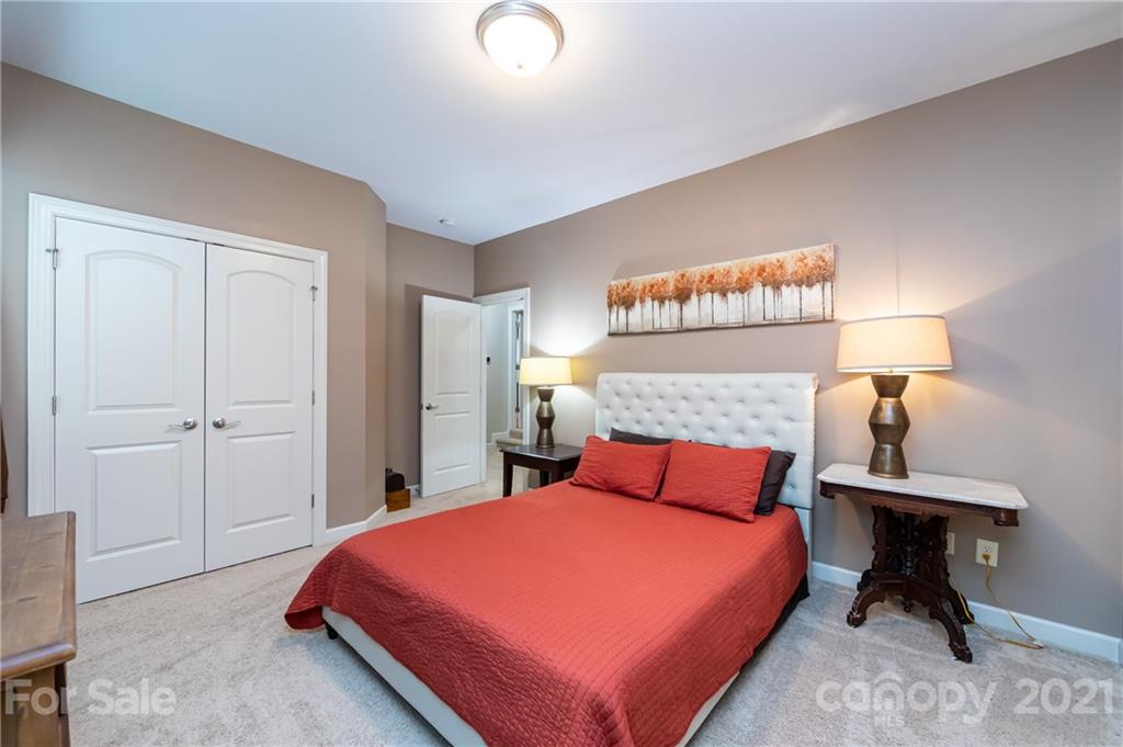 2721 Twinberry Lane Waxhaw, NC 28173 - Photo 24 of 29 a bedroom with a bed and a lamp on table