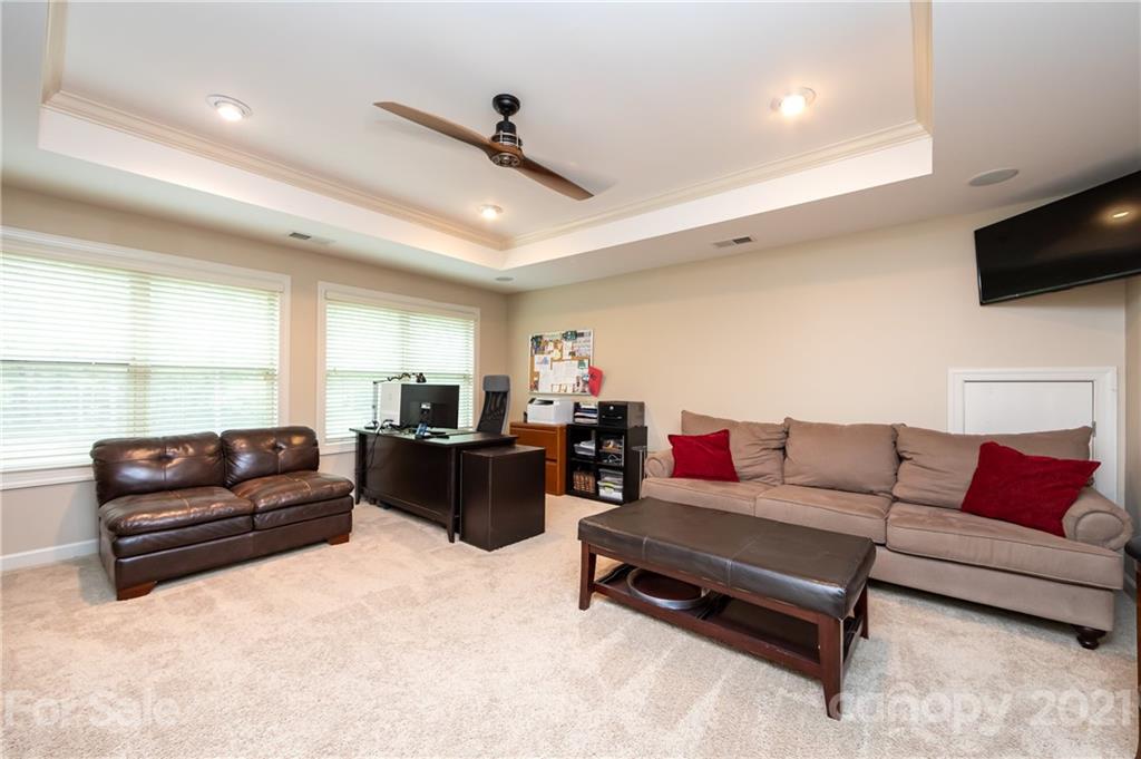 2721 Twinberry Lane Waxhaw, NC 28173 - Photo 27 of 29 a living room with furniture and a flat screen tv