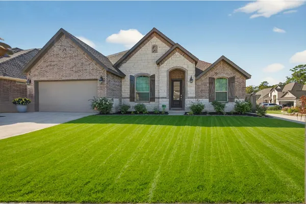 a front view of house with yard and green space