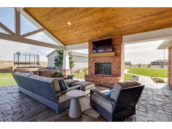 a living room with fireplace furniture and a floor to ceiling window