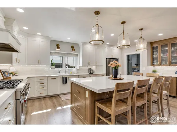 a large kitchen with kitchen island a sink table and chairs