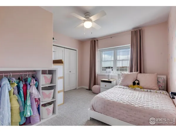 a bedroom with furniture and a large window