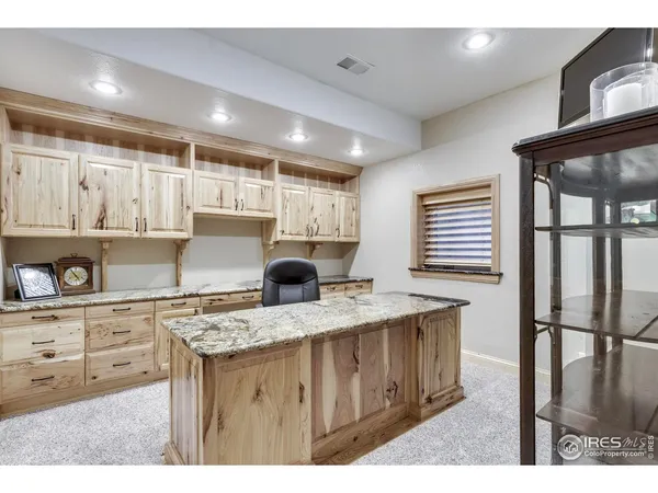 a bathroom with a granite countertop sink a toilet a mirror and shower